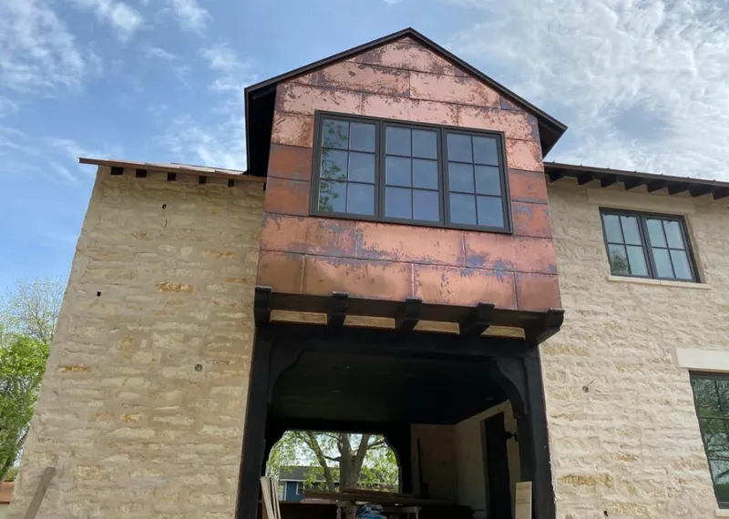 Copper metal panel facade on a stone building for Skylight Installation in Bernardsville